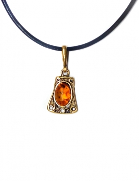 1888 Brass pendant with burned Amber