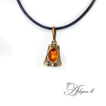 1888 Brass pendant with burned Amber